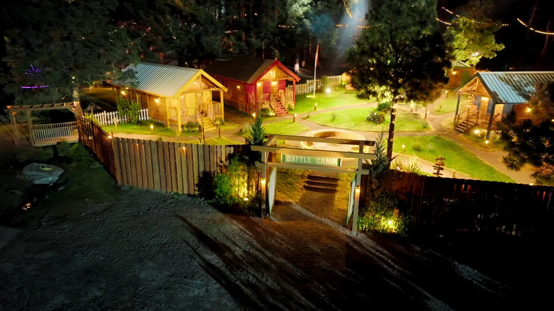 Battle Camp Netflix cabins and exterior camp set lit for night-time multicamera filming in Mexico